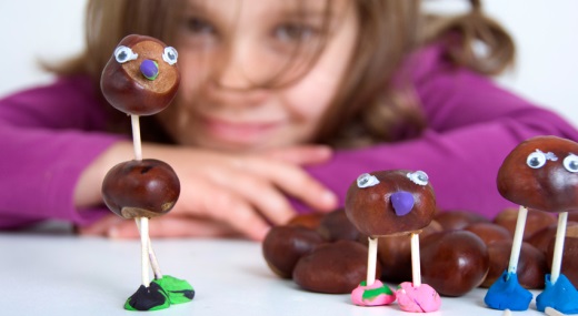 Kastanienfiguren und im Hintergrund ein Mädchen