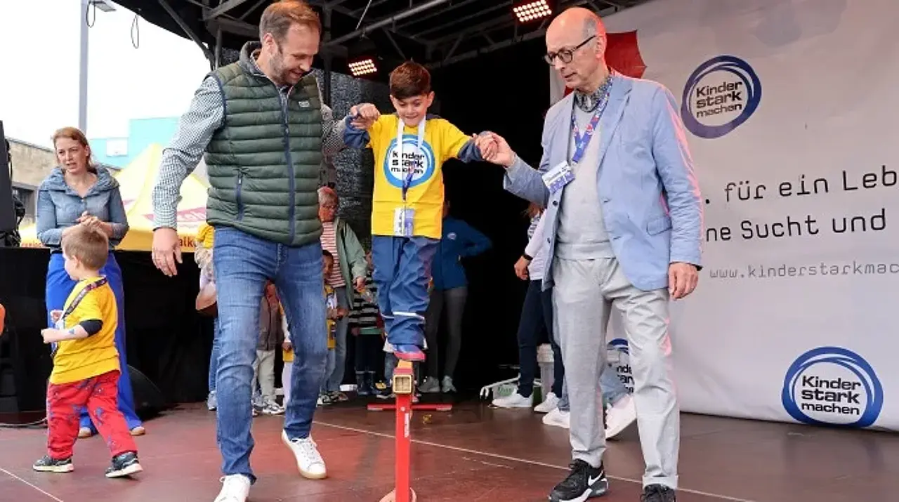 © Carsten Kobow Robert Voigtsberger und Dr. Johannes Nießen reichen einem Jungen beim Balancieren eine helfende Hand.