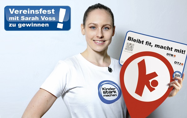 Sarah Voss hält ein Schild der Bewegungshaltestellen in der Hand